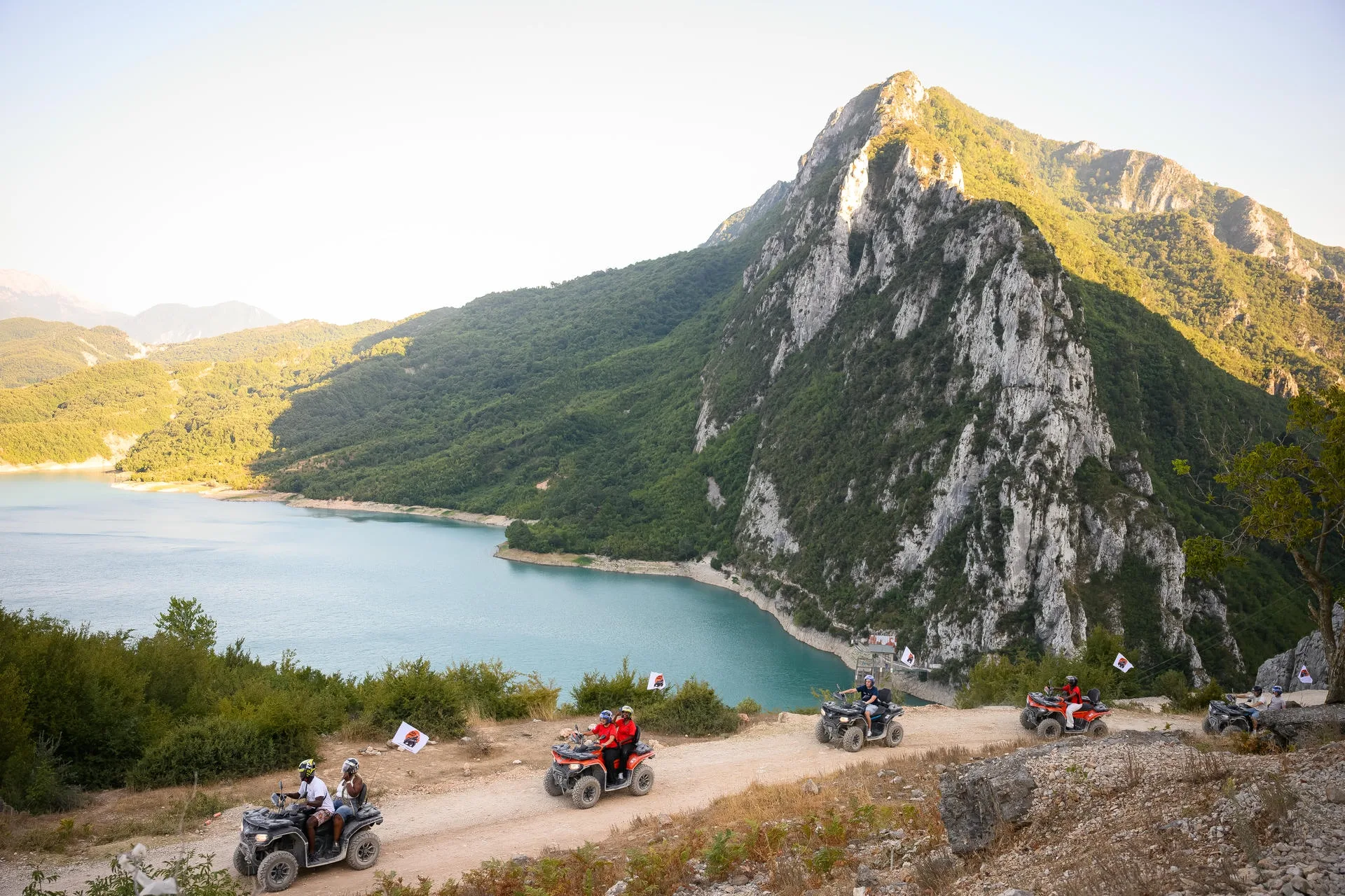 ATV Tirana riders crossing the mountainside above Bovilla Lake beneath the Gamti cliffs
