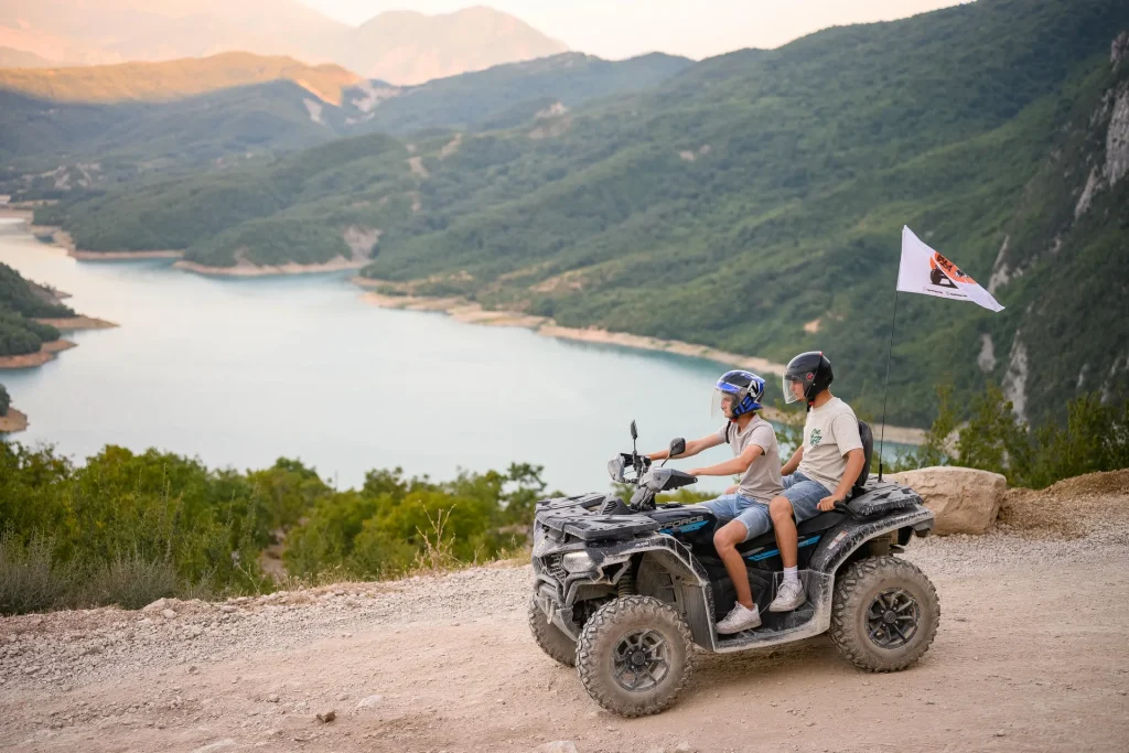 Two guests riding together on an ATV Tirana quad bike above Bovilla Lake