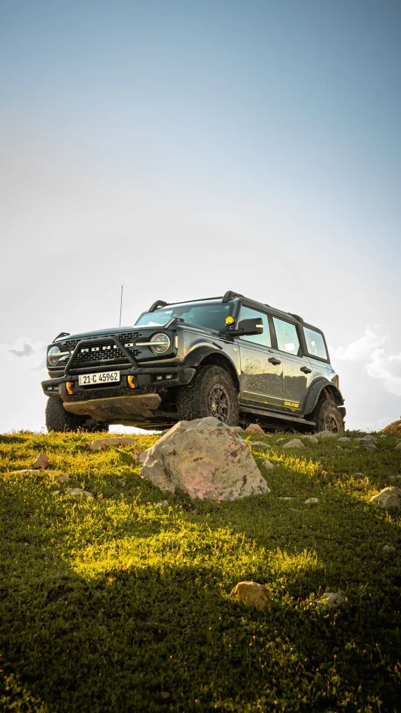 Illustrative 4x4 vehicle on rugged mountain terrain